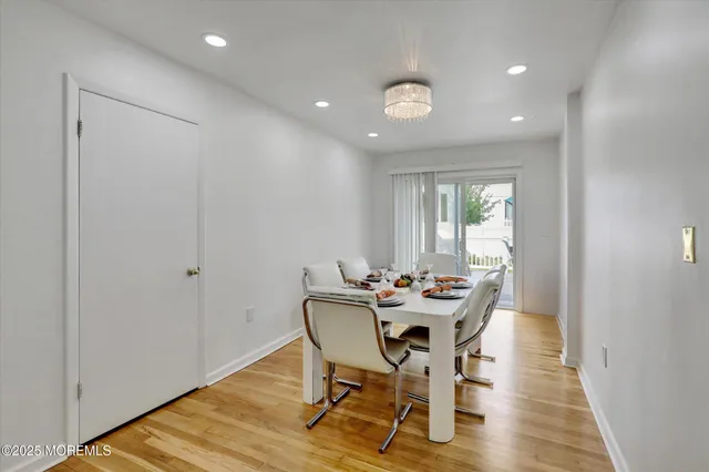 a dining room with furniture and wooden floor