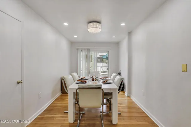 a dining room with furniture and wooden floor