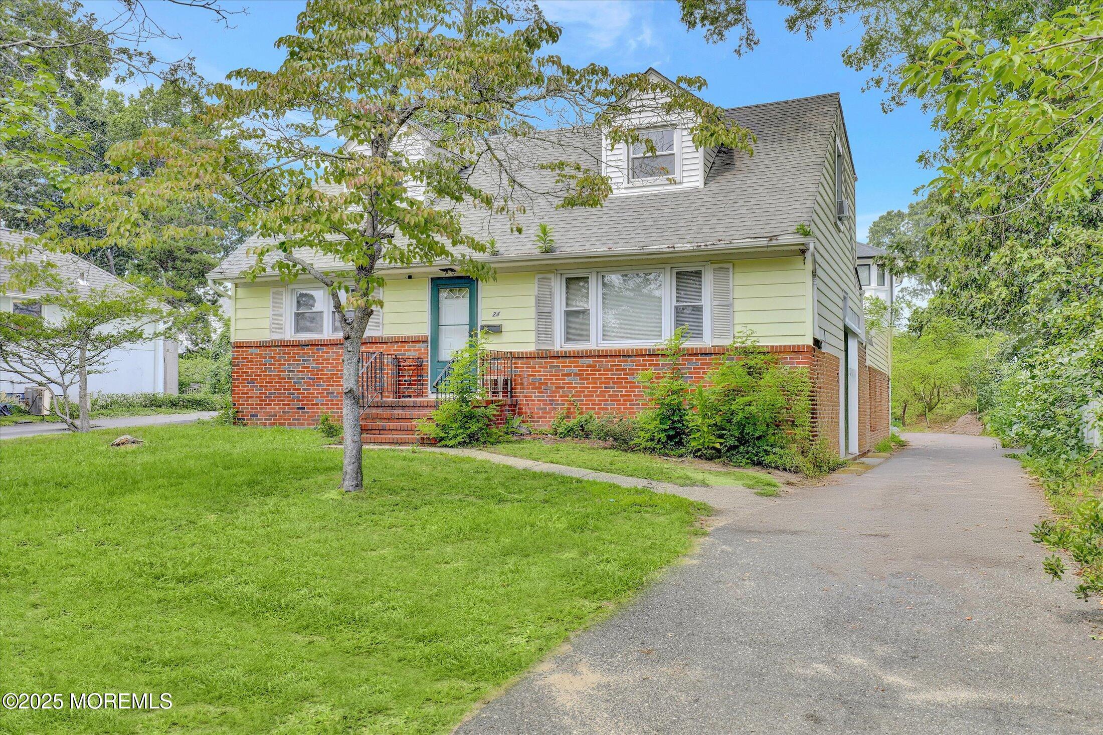 24 Berger Avenue Oakhurst, NJ 07755 - Photo 2 of 49 a front view of a house with garden
