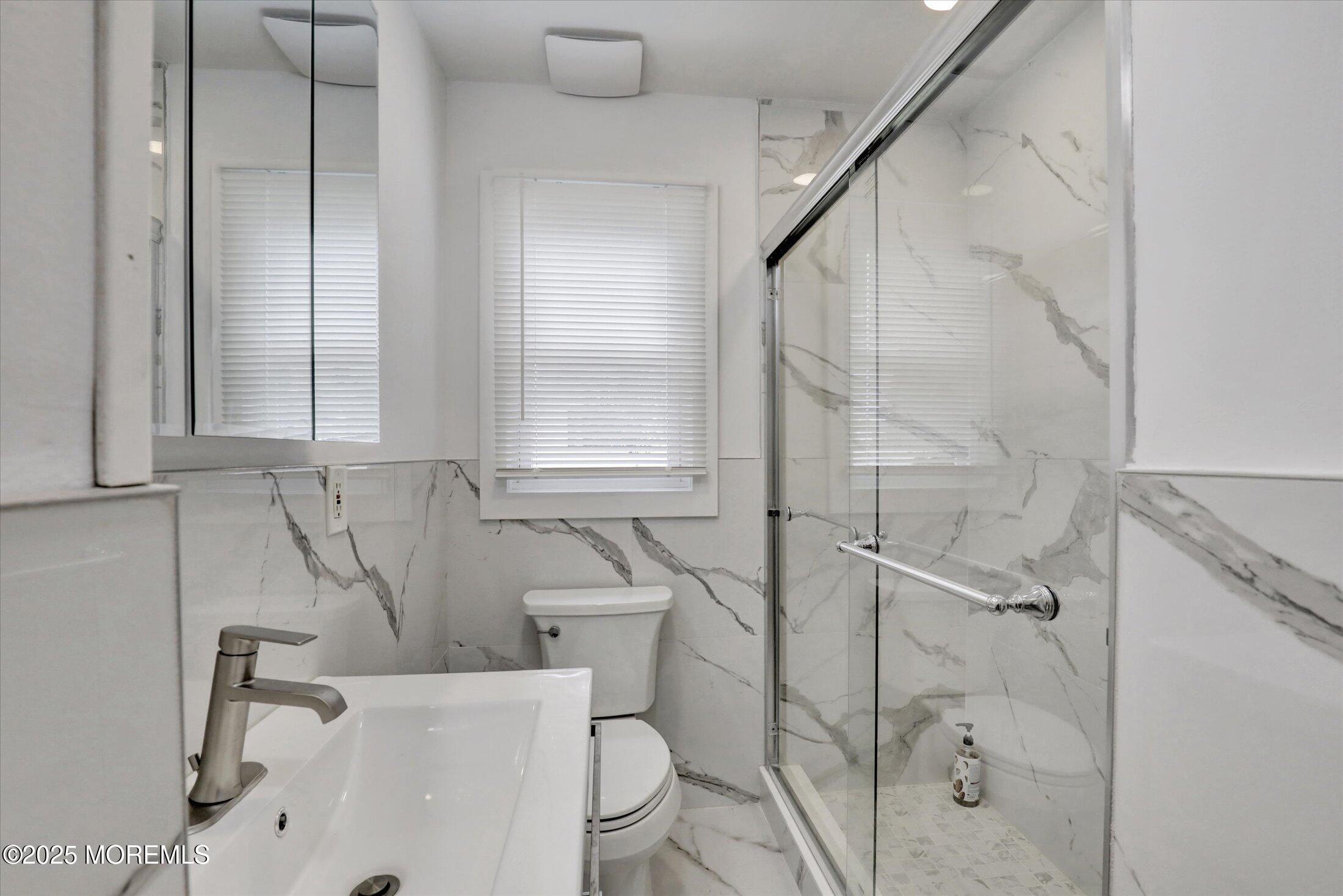 24 Berger Avenue Oakhurst, NJ 07755 - Photo 23 of 49 a bathroom with a sink a toilet and shower