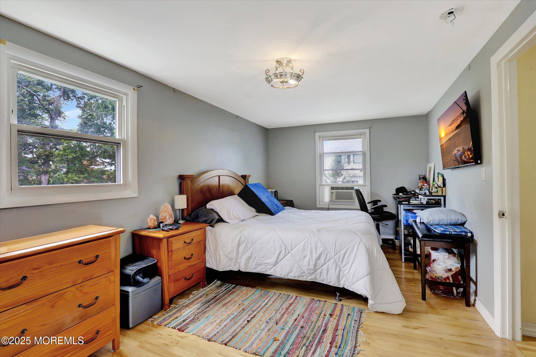 24 Berger Avenue Oakhurst, NJ 07755 - Photo 25 of 49 a bedroom with a bed and wooden floor