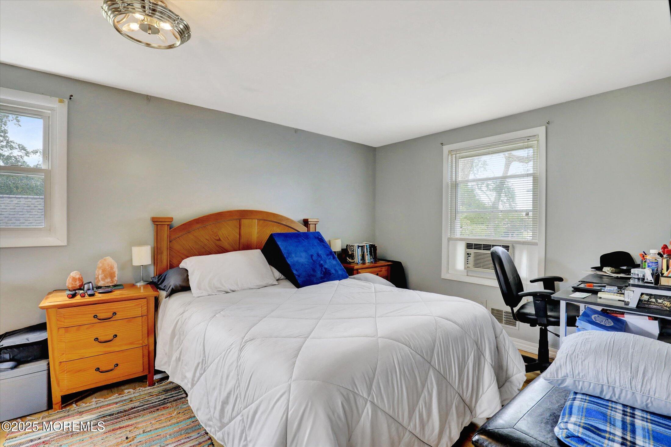 24 Berger Avenue Oakhurst, NJ 07755 - Photo 26 of 49 a bedroom with a bed and wooden floor