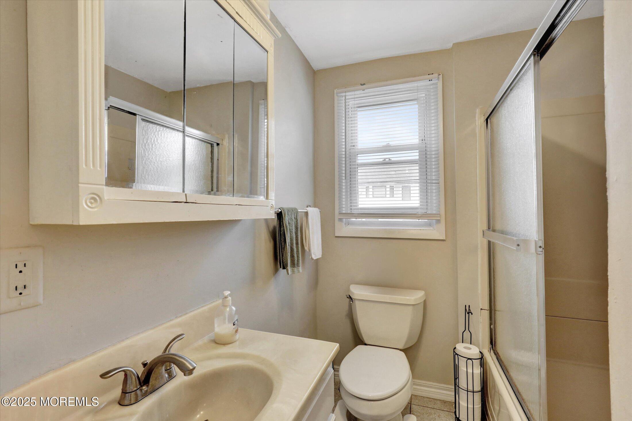 24 Berger Avenue Oakhurst, NJ 07755 - Photo 28 of 49 a bathroom with a toilet sink and mirror