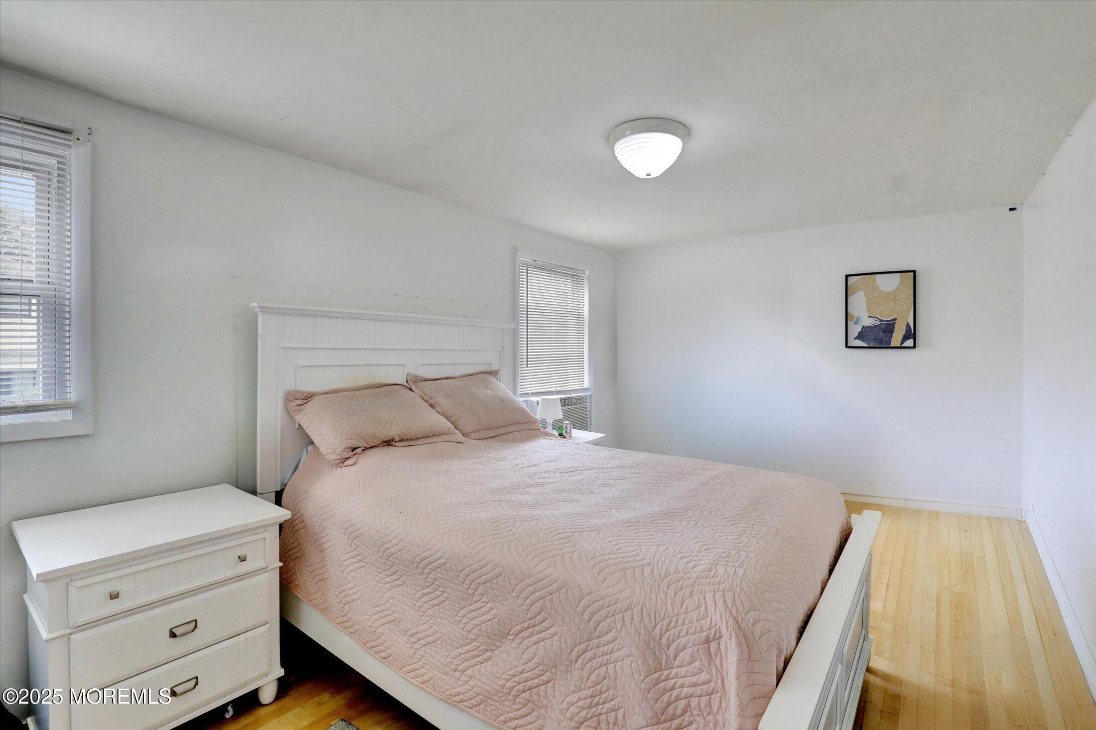 24 Berger Avenue Oakhurst, NJ 07755 - Photo 29 of 49 a bedroom with a bed and a night stand