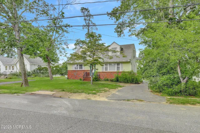 a front view of a house with a yard and a garage