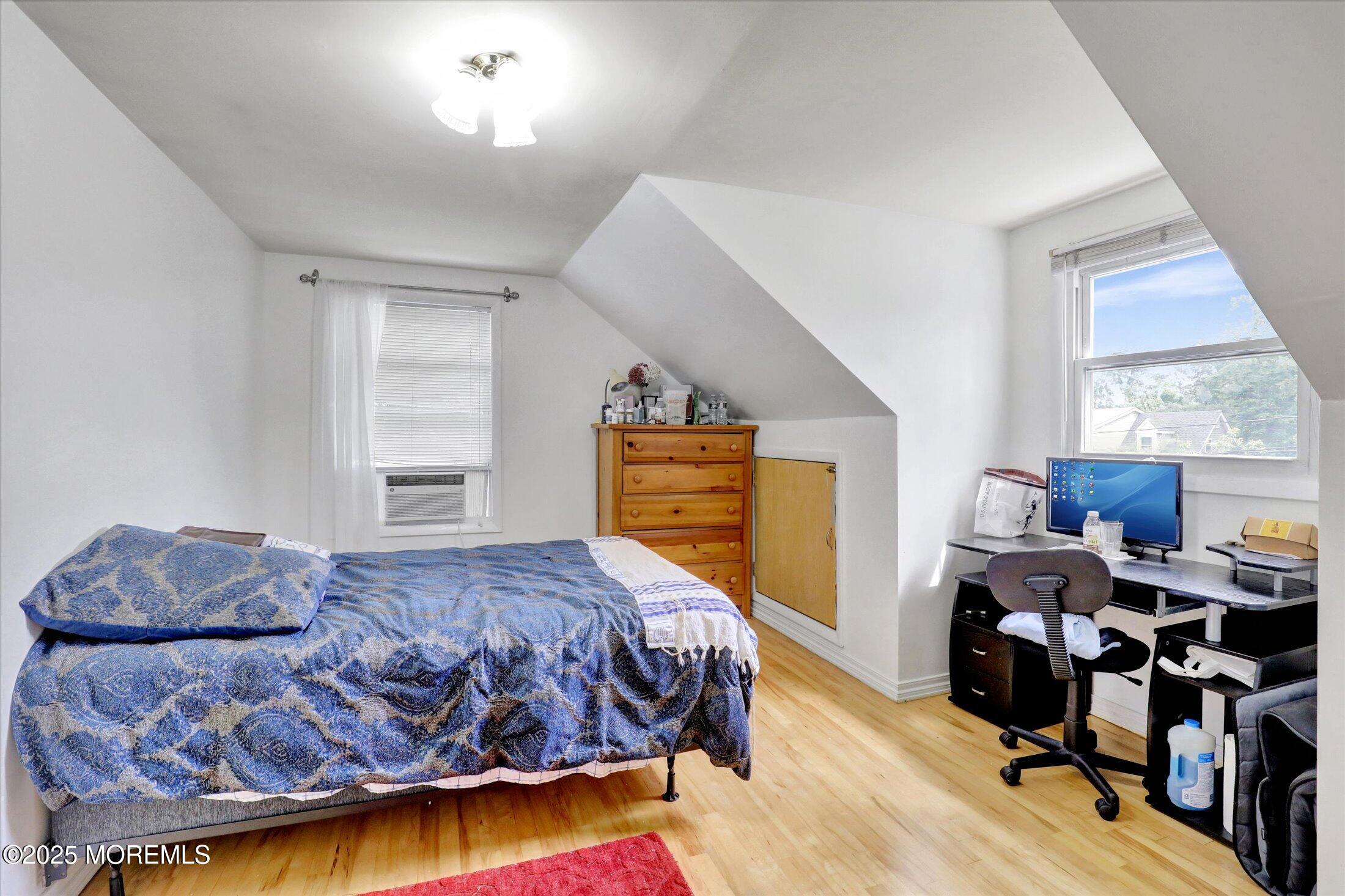 24 Berger Avenue Oakhurst, NJ 07755 - Photo 31 of 49 a bedroom with a bed and wooden floor