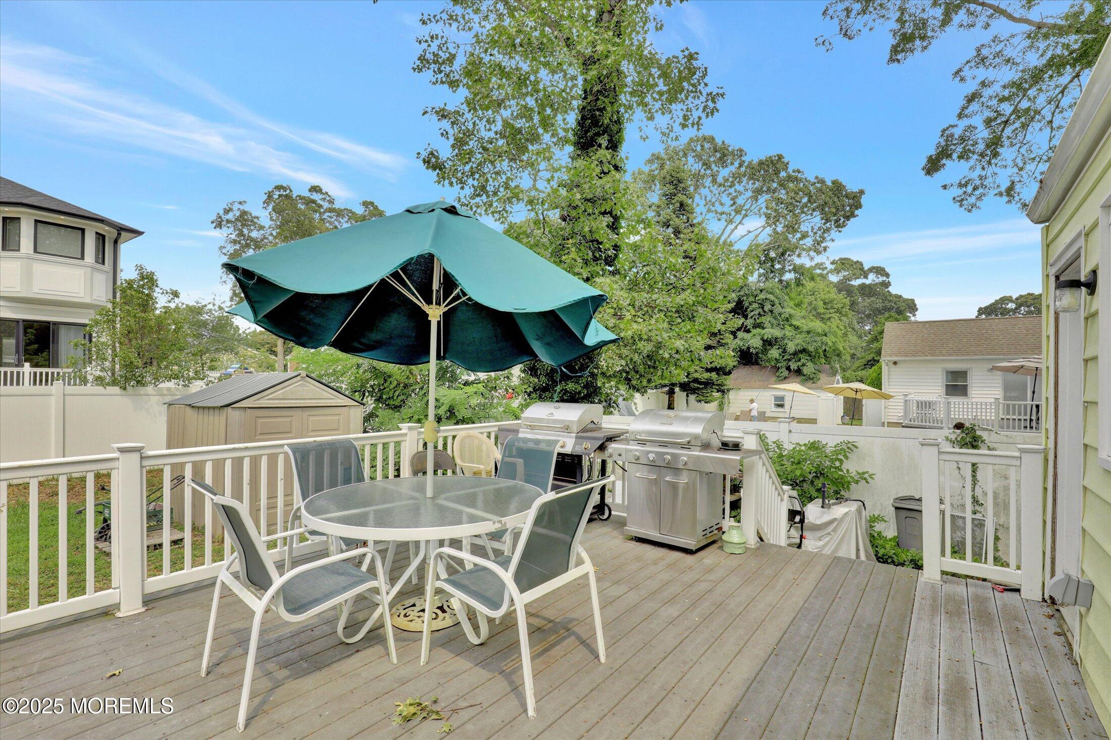 24 Berger Avenue Oakhurst, NJ 07755 - Photo 34 of 49 a view of a patio with table and chairs and potted plants