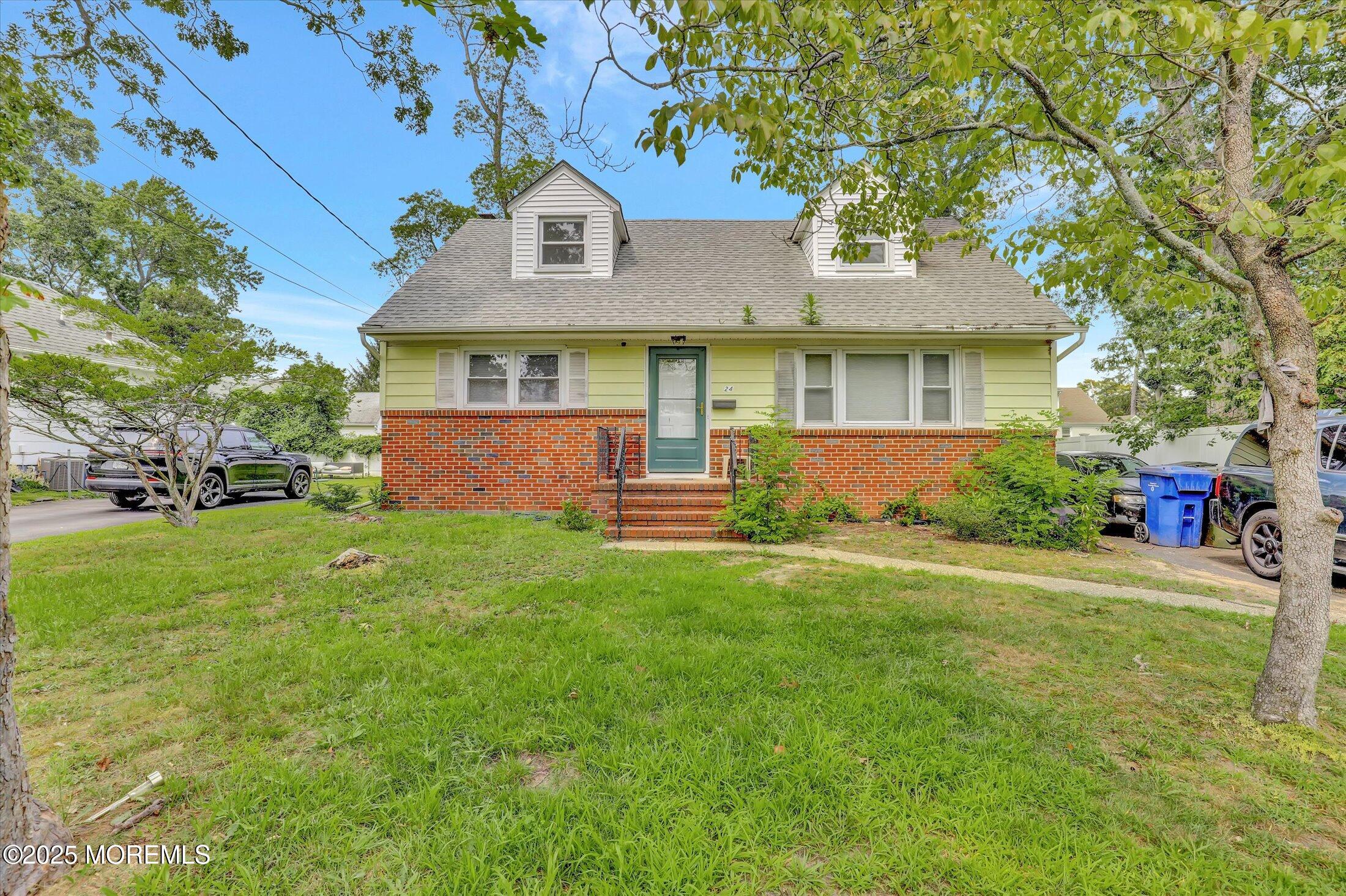 24 Berger Avenue Oakhurst, NJ 07755 - Photo 4 of 49 front view of a house with a yard