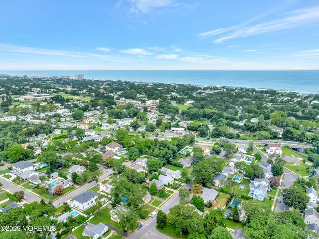 an aerial view of residential houses with city view