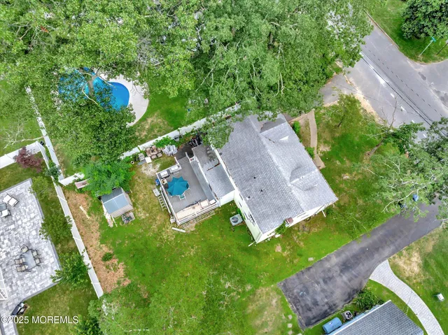 an aerial view of a house with a yard basket ball court and outdoor seating