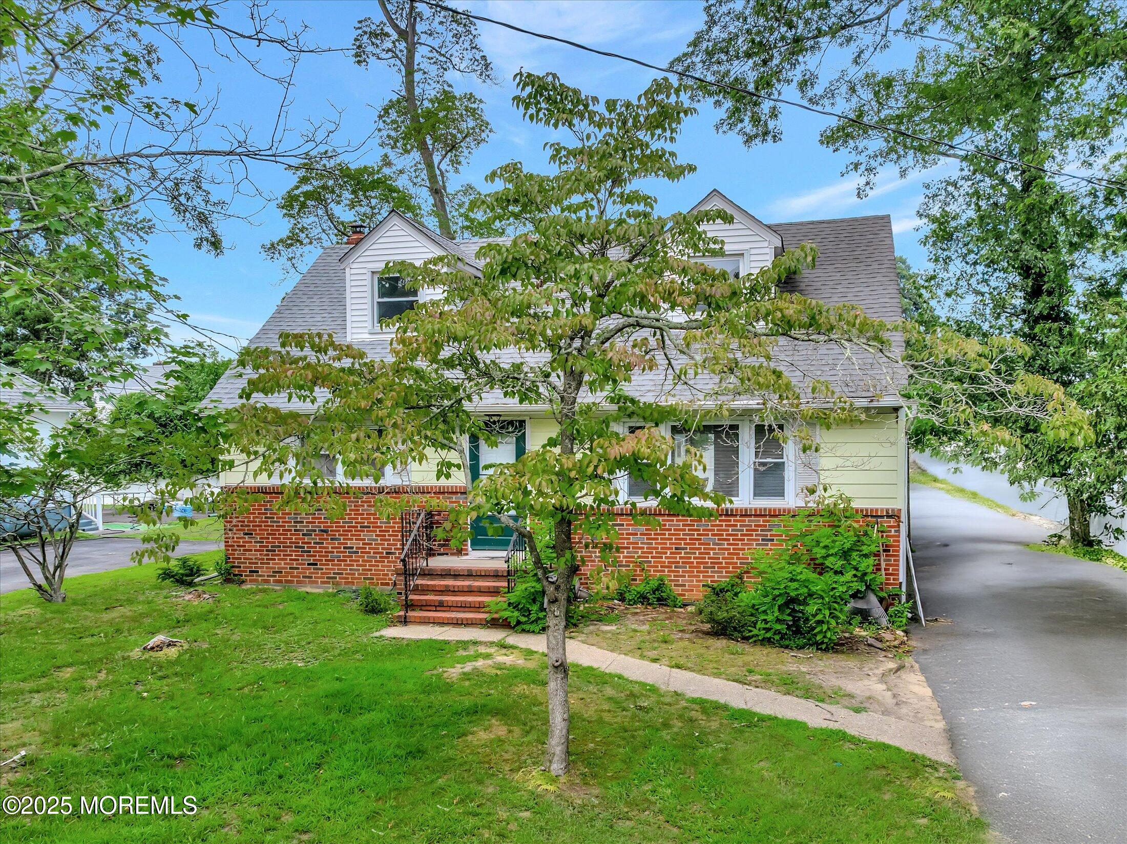 24 Berger Avenue Oakhurst, NJ 07755 - Photo 5 of 49 a front view of a house with a garden