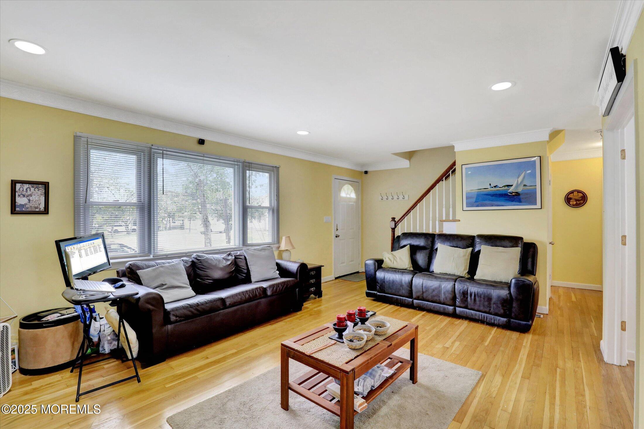 24 Berger Avenue Oakhurst, NJ 07755 - Photo 9 of 49 a living room with furniture and a wooden floor