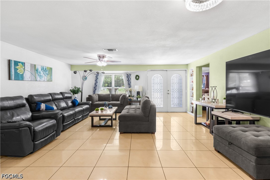 18 Illinois Road Lehigh Acres, FL 33936 - Photo 12 of 45 a living room with furniture and a flat screen tv