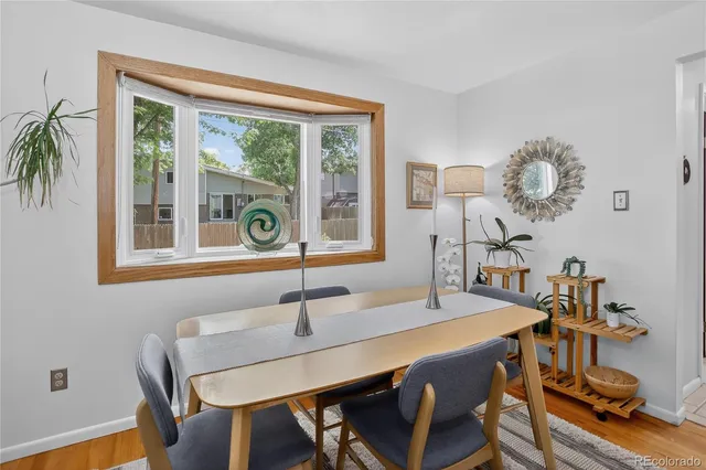 a view of a dining room with a table and chairs