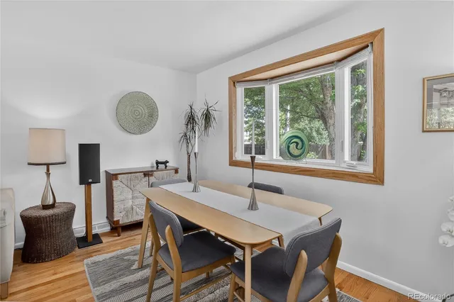 a view of a dining room with furniture window and wooden floor