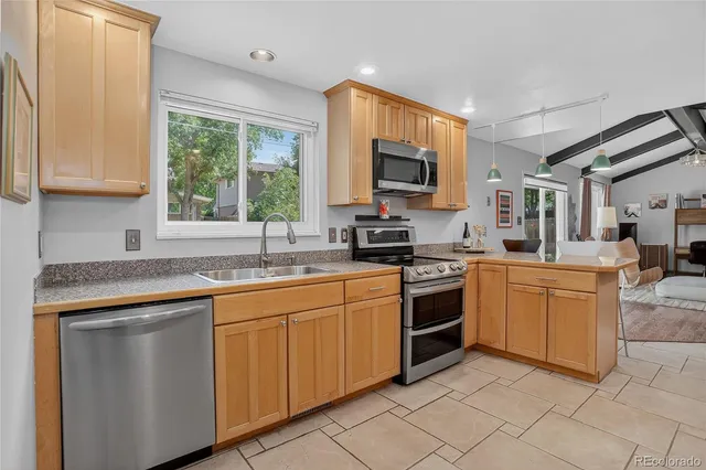 a kitchen with stainless steel appliances granite countertop a stove sink and microwave