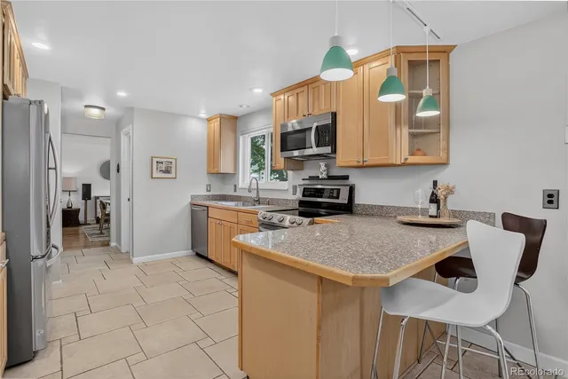 a kitchen with a sink cabinets and wooden floor