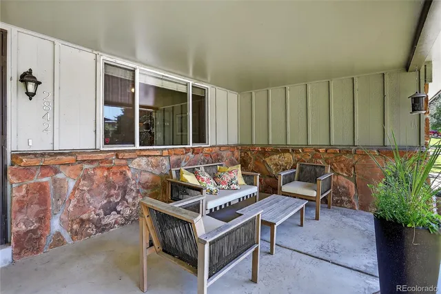 a view of a patio with table and chairs