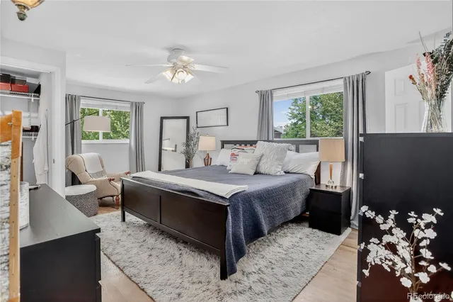 a bedroom with a bed mirror and window
