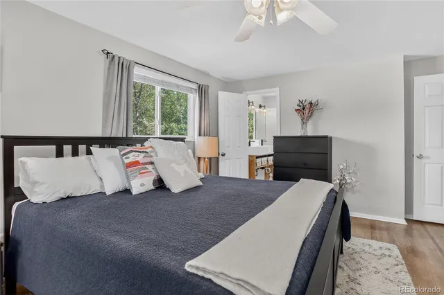 a bed sitting in a bedroom next to a window with a dresser