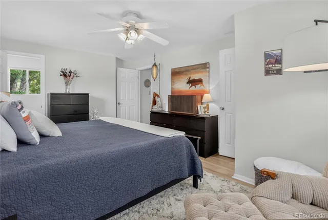 a bedroom with a bed and ceiling fan