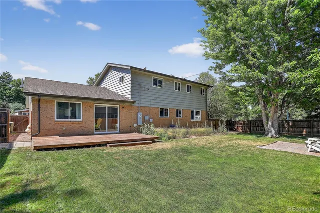 a front view of a house with a yard table and chairs