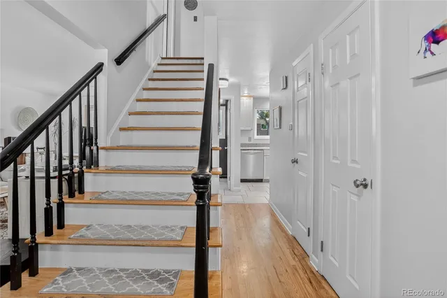 a view of a hallway with wooden floor and entryway