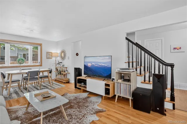 a living room with furniture and wooden floor