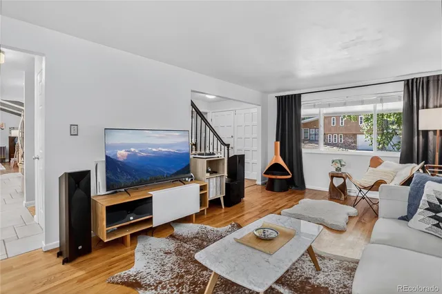 a living room with furniture fireplace and a window