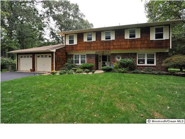41 Eaglenest Road Freehold, NJ 07728 - Photo 1 of 16 a black and white house with a yard