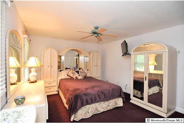 41 Eaglenest Road Freehold, NJ 07728 - Photo 13 of 16 a bedroom with a bed and wooden floor