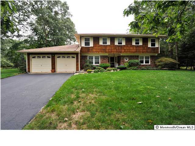 41 Eaglenest Road Freehold, NJ 07728 - Photo 16 of 16 a view front of house with a yard and potted plants