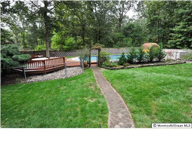 41 Eaglenest Road Freehold, NJ 07728 - Photo 3 of 16 a view of a garden with wooden fence