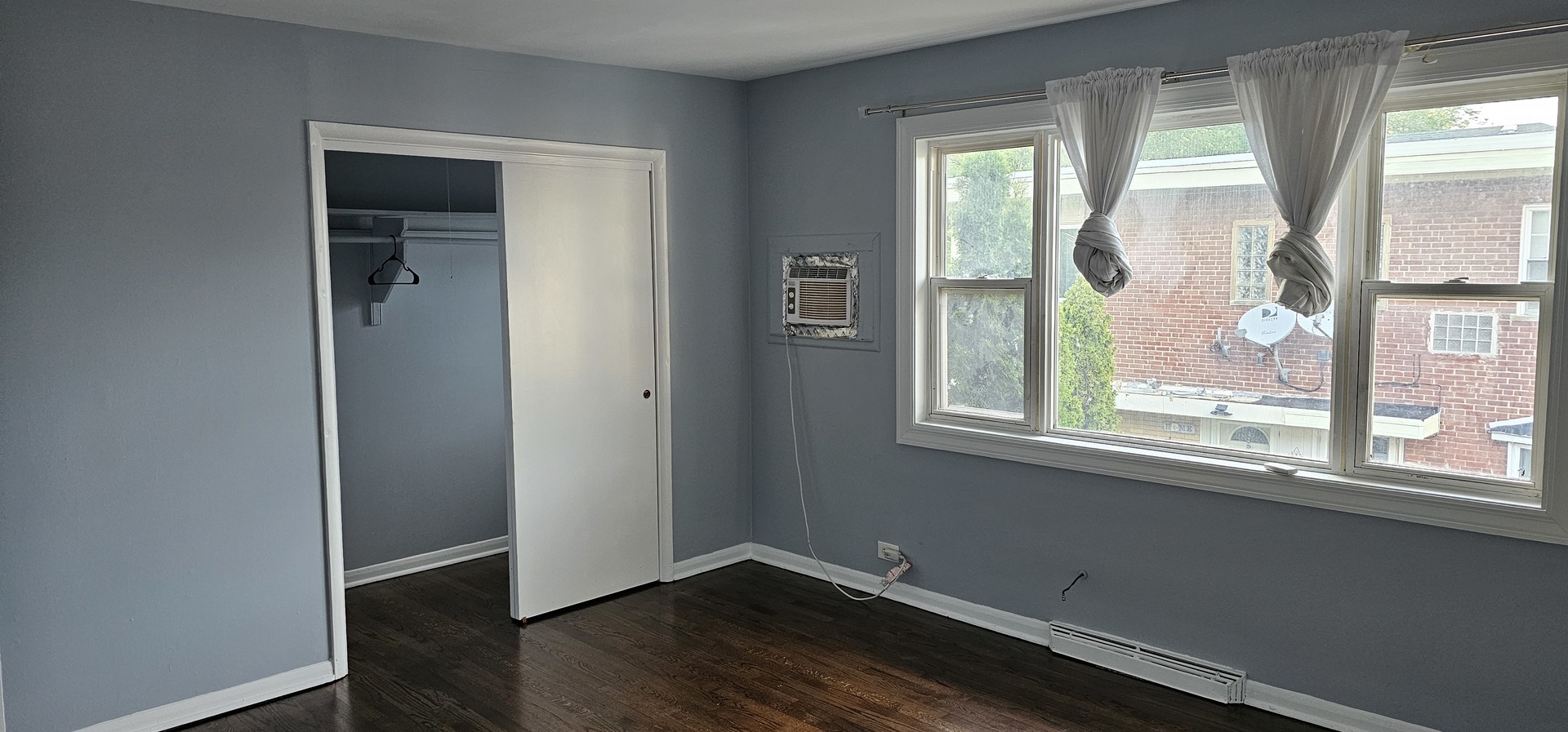 5115 North Springfield Avenue, Unit B Chicago, IL 60625 - Photo 2 of 11 an empty room with wooden floor and a window