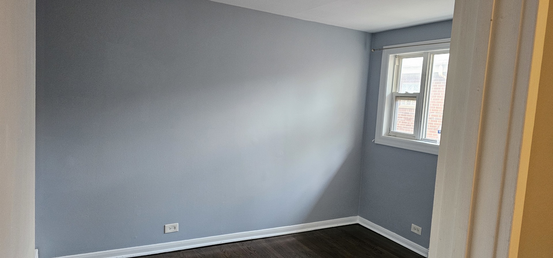 5115 North Springfield Avenue, Unit B Chicago, IL 60625 - Photo 3 of 11 a view of an empty room with wooden floor and a window