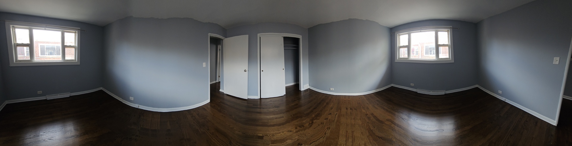5115 North Springfield Avenue, Unit B Chicago, IL 60625 - Photo 7 of 11 an empty room with wooden floor and windows