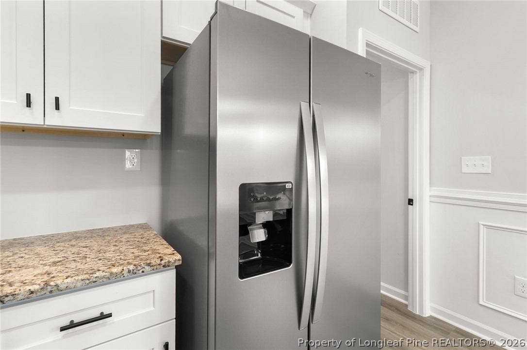 802 Holmes Street Clinton, NC 28328 - Photo 10 of 31 a kitchen with a refrigerator and cabinets