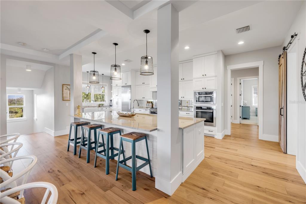1 Mar Azul North Ponce Inlet, FL 32127 - Photo 27 of 76 a kitchen with stainless steel appliances kitchen island granite countertop a table chairs and a refrigerator