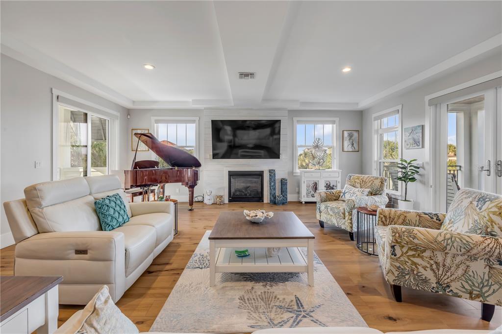 1 Mar Azul North Ponce Inlet, FL 32127 - Photo 29 of 76 a living room with furniture a flat screen tv and a fireplace