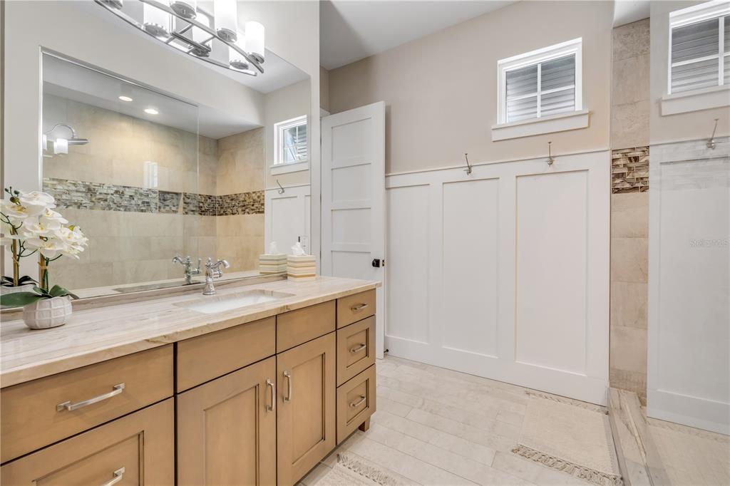 1 Mar Azul North Ponce Inlet, FL 32127 - Photo 40 of 76 a bathroom with a granite countertop sink a mirror and a shower
