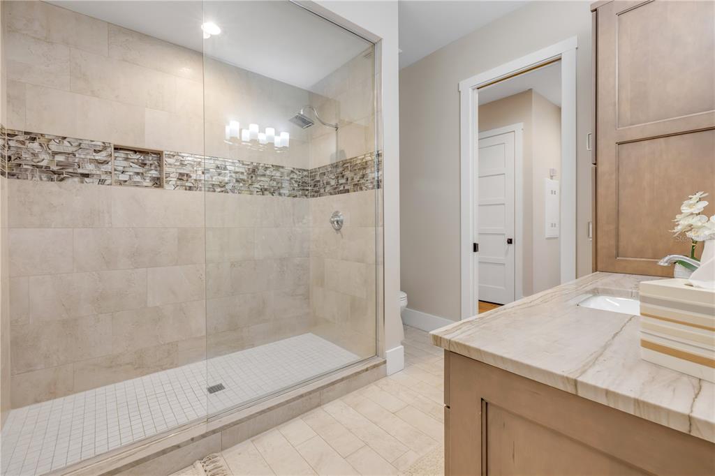 1 Mar Azul North Ponce Inlet, FL 32127 - Photo 41 of 76 a bathroom with a granite countertop sink a shower and a mirror