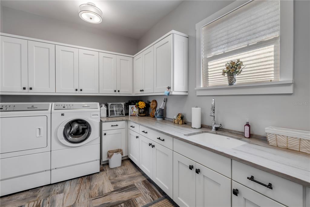 1 Mar Azul North Ponce Inlet, FL 32127 - Photo 42 of 76 a kitchen with granite countertop white cabinets and white appliances