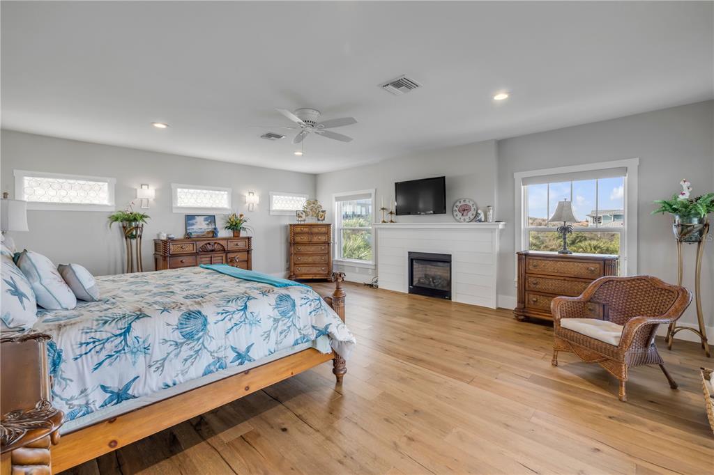 1 Mar Azul North Ponce Inlet, FL 32127 - Photo 46 of 76 a living room with furniture a fireplace and a flat screen tv