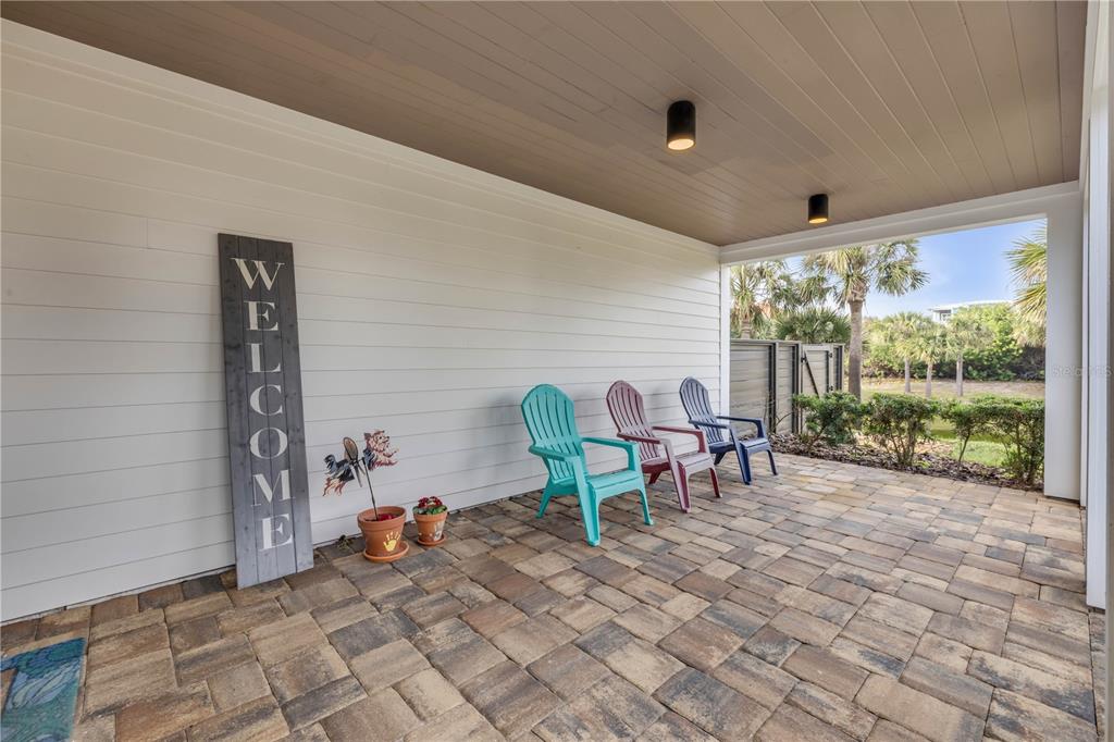 1 Mar Azul North Ponce Inlet, FL 32127 - Photo 8 of 76 a view of a porch with chairs and backyard
