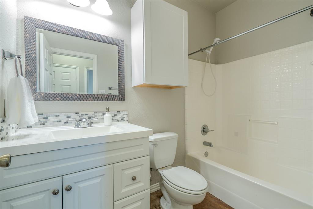 403 Summer Tree Lane Springtown, TX 76082 - Photo 11 of 19 Bathroom featuring a white vanity with a shower tub combo.
