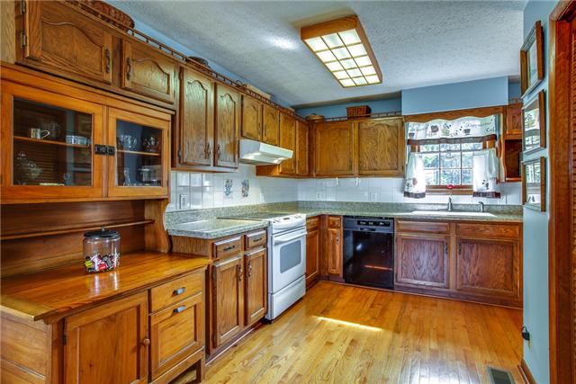6289 Meeks Road Franklin, TN 37064 - Photo 7 of 20 L-shaped kitchen has a new tile backsplash and recessed refrigerator. There is a built-in area for the refrig if you want it out in full view.