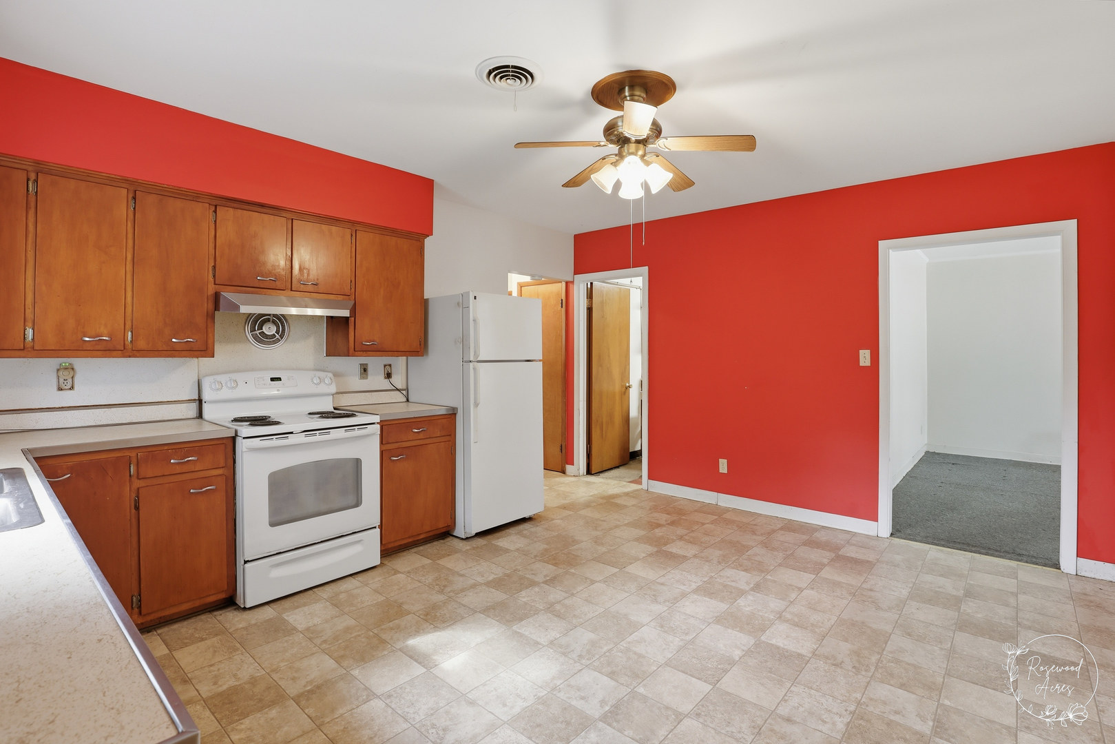 409 Main Street Crescent City, IL 60928 - Photo 7 of 22 a kitchen with stainless steel appliances granite countertop a sink a stove a refrigerator cabinets and entryway