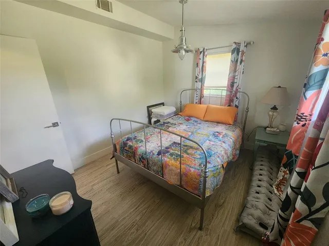 a bedroom with a bed and a chandelier