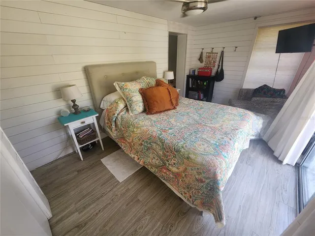 a bed sitting in a bedroom and chair