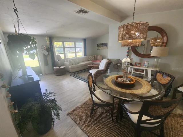 a living room with dining table and chairs